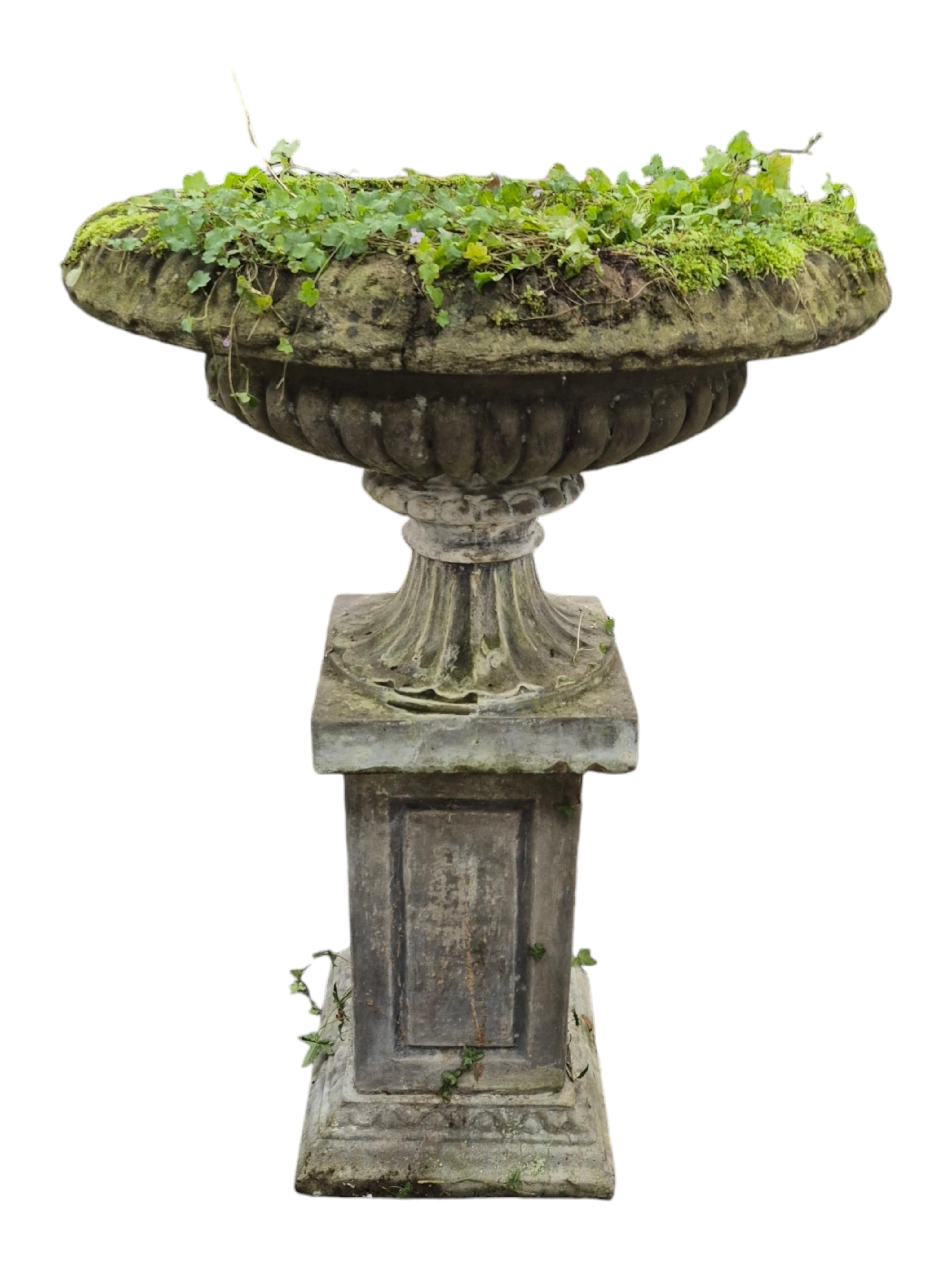 A large reconstituted stone garden vase